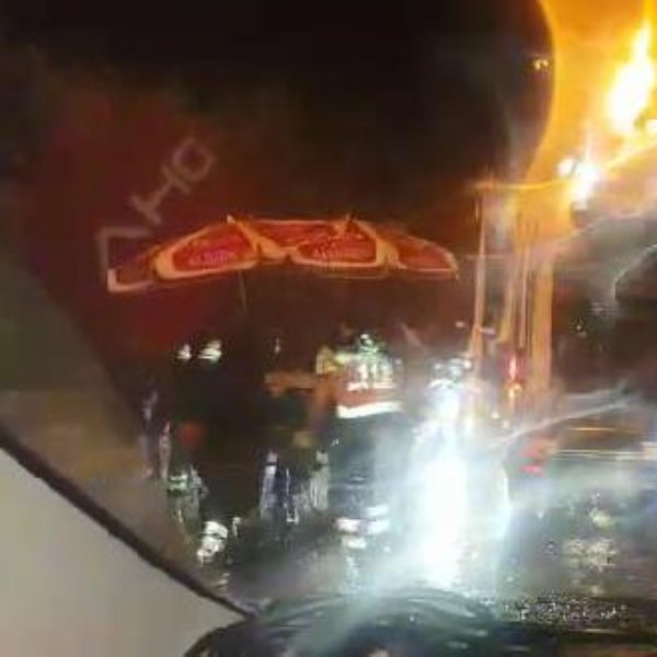 Bursa'da kaza yapan sürücüyü şemsiyeyle korudular
