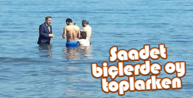 Milletvekili adayı takım elbise ile denize girdi