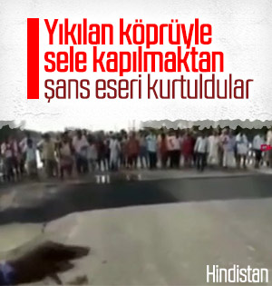 Köprünün yıkılmasına aldırış etmeyen meraklı kalabalık