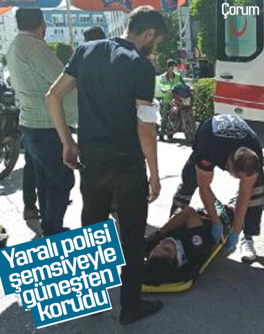 Çorum'da kaza yapan yaralı polise şemsiyeli koruma
