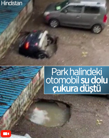 Hindistan’da park halindeki otomobil, su dolu çukura düştü