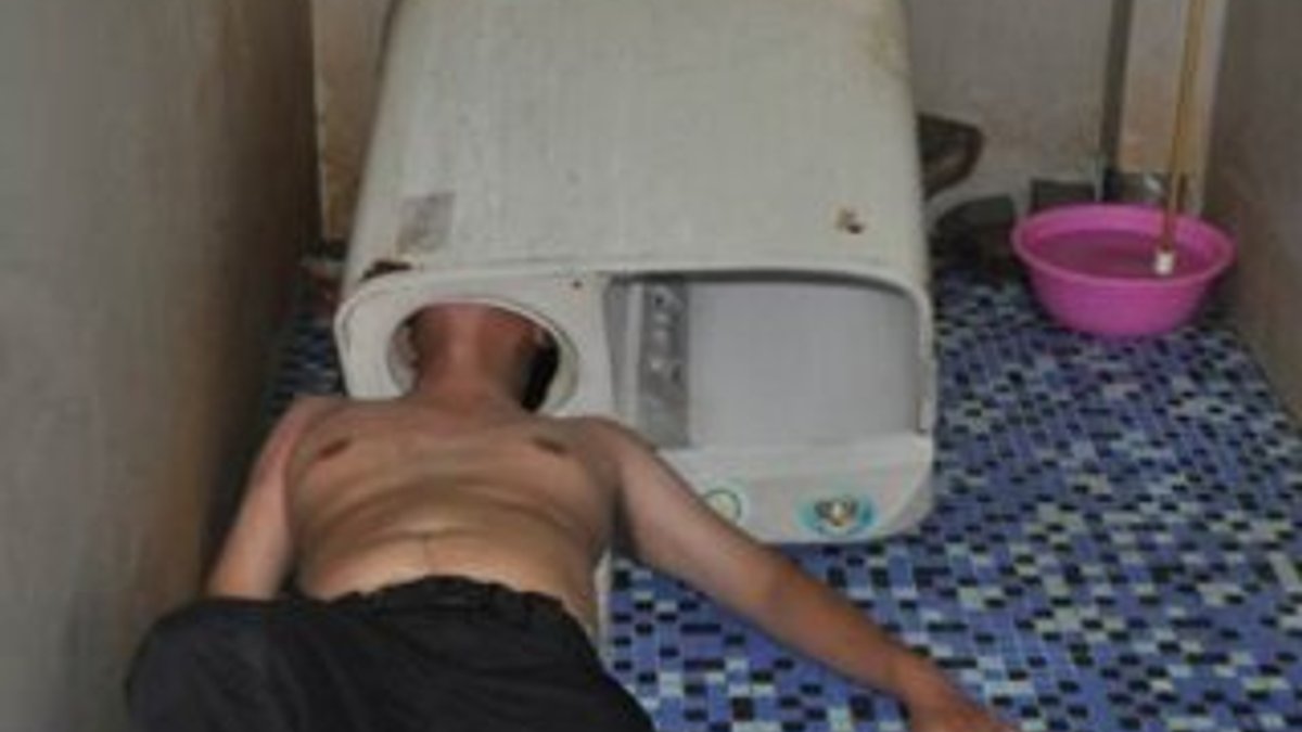 Çinli genç kafasını çamaşır makinesine sıkıştırdı
