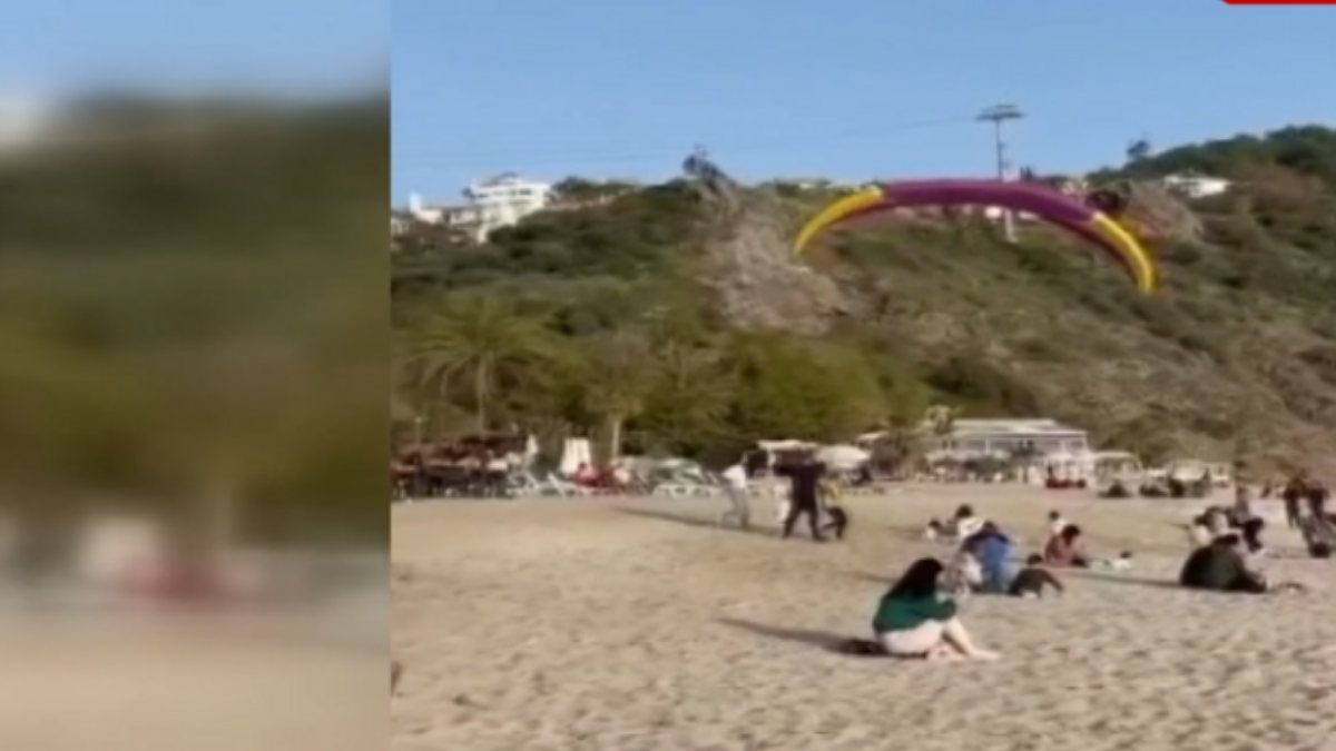 Antalya'da sahile iniş yapan paraşütçü, turistle çarpıştı