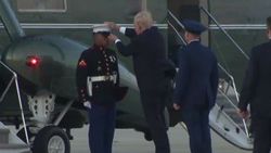 Trump askerin rüzgardan uçan şapkasını kovaladı