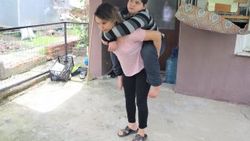 Yüzde 99 engelli Berat, annesinin sırtında sokağa çıkıyor