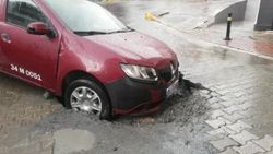 Şiddetli yağış yolu çökertti, taksi çukura düştü