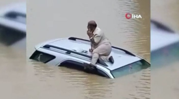 Hindistan’da selde mahsur kalan sürücü aracının üzerinde kurtarılmayı bekledi -1