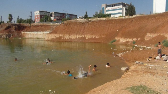 Çocuklar, inşaat temelini dolduran kirli suda yüzüyor -5