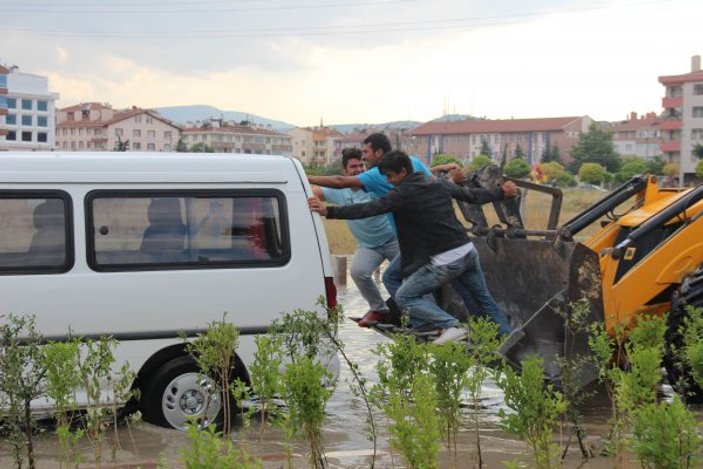 Suda mahsur kalan minibüsü kepçe kurtardı