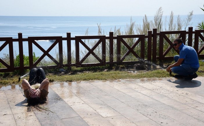 Antalya'da parkta yatan kadın fıskiye ile temizlendi