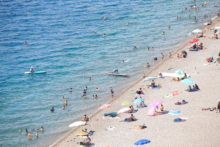 Antalya'da sıcaktan bunalan turistler sahilleri doldurdu