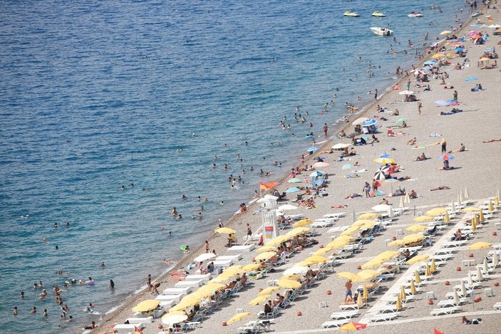 Antalya'da sıcaktan bunalan turistler sahilleri doldurdu