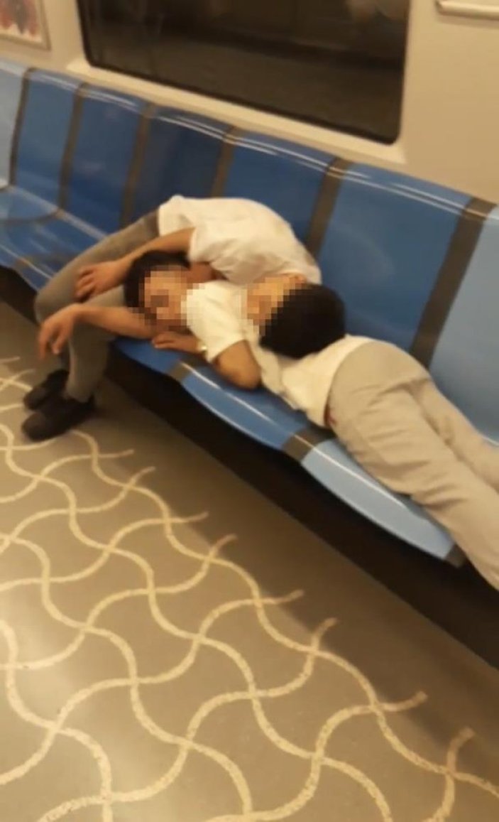 Metroda koltuklara uzanarak uyuyan bir grup genç kamerada