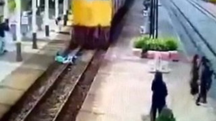Taylandlı genç trenin altından sağ kurtuldu