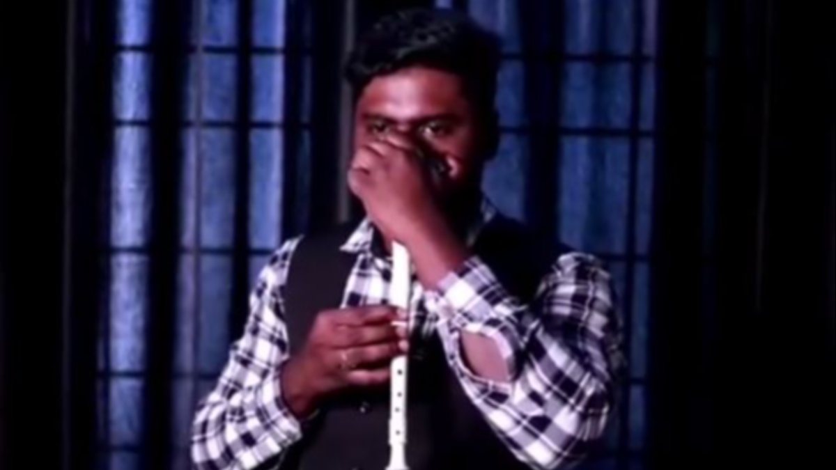 Beatbox show by Indian musician playing the harmonica with his nose
