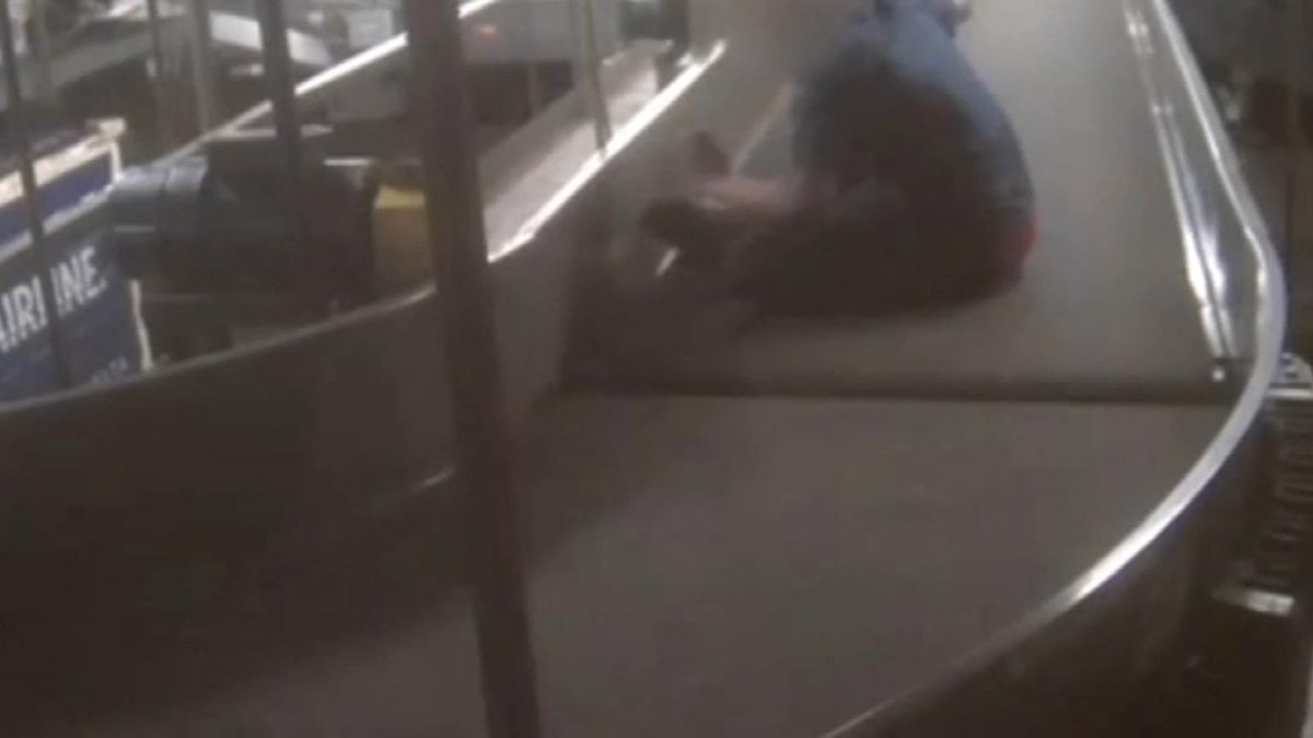 A child with autism is on camera, entering the luggage conveyor belt in the USA