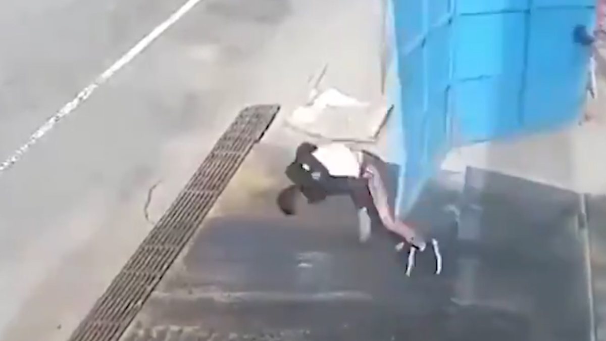 Iron door slammed on man bending over in China