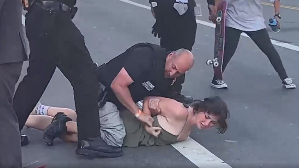 Tough action from the police on the woman protesting Joe Biden