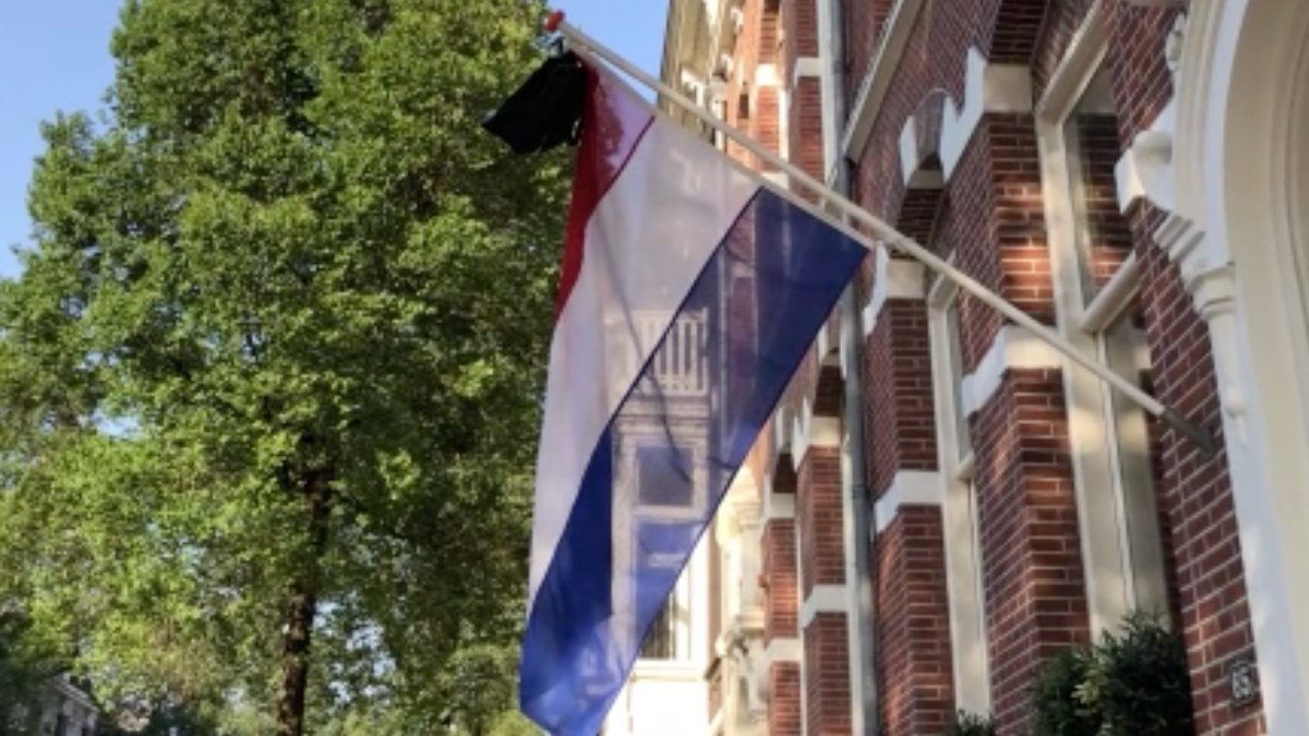 High school students in the Netherlands announce their graduation by hanging flags and bags on their houses.