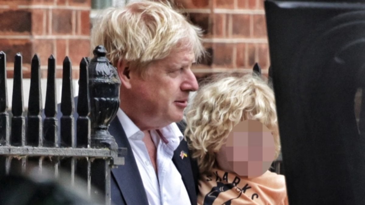 Boris Johnson and his son Wilfred reflected in the lenses