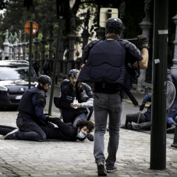 Belgian police kneel on top of teenager for minutes