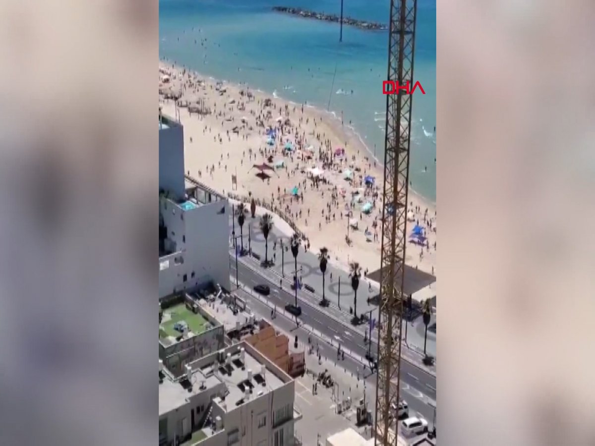 Moments of Israelis on the beach rushing to shelters on camera #3