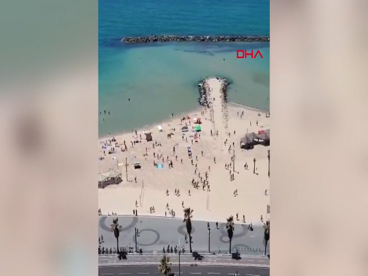 The moments when Israelis on the beach rush to the shelters on camera #2