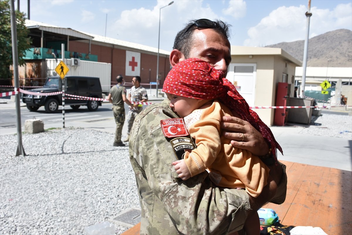 Turkish soldier extends his hand of compassion to baby Hadiya who is separated from her mother in Kabul #5