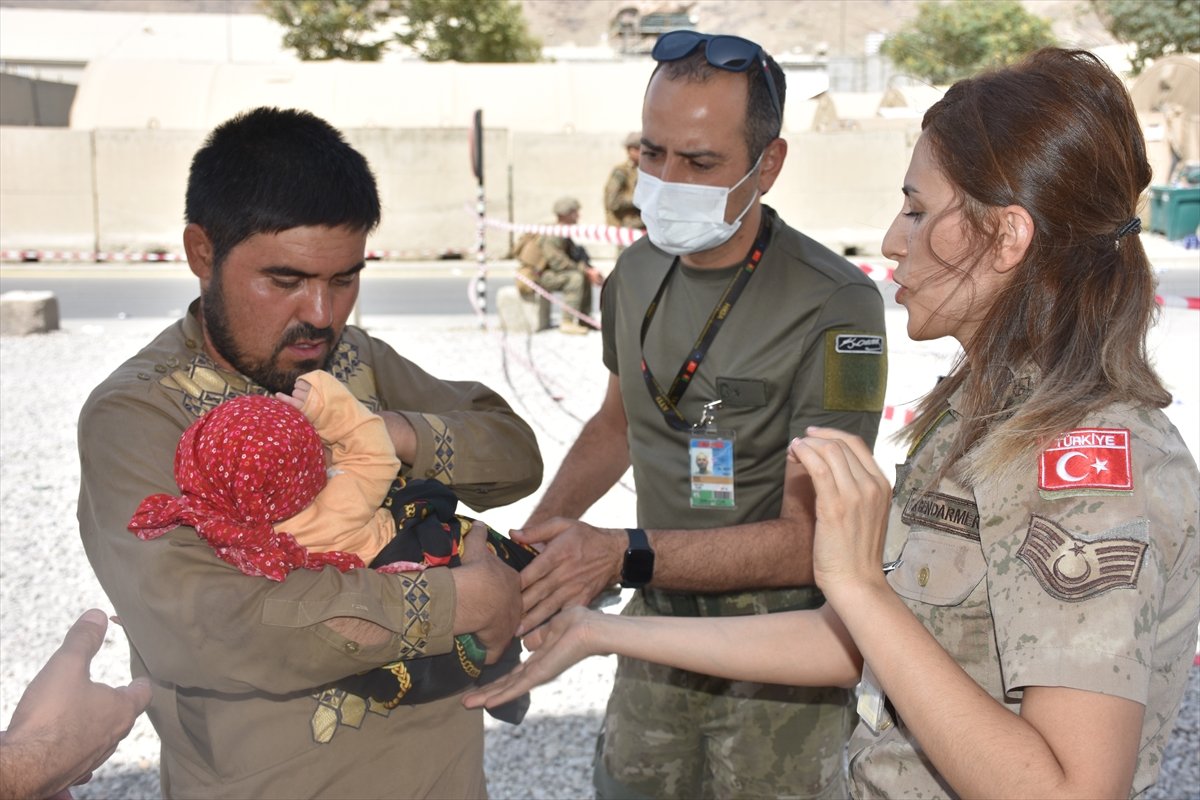 Turkish soldier extends his hand of compassion to baby Hadiya who is separated from her mother in Kabul #8
