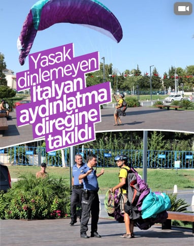Antalya'da yasağa aldırmayan İtalyan paraşütçü aydınlatma direğine takıldı