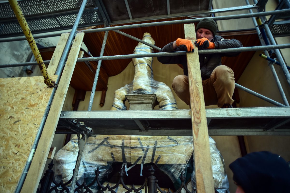 Latin Cathedral, showcases and statues protected by wooden boards in Ukraine #3