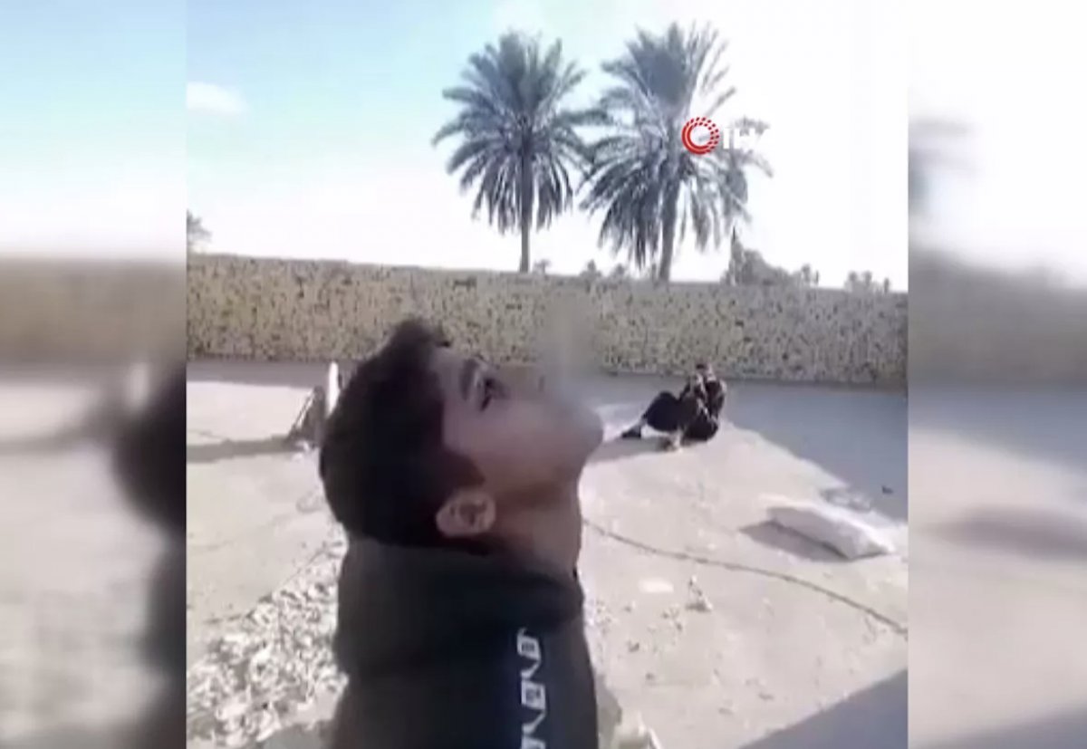 Iraklı baba, oğlunun ağzındaki sigarayı mermiyle vurdu #1