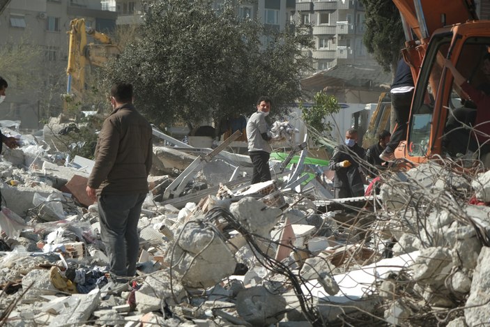 Antakya'da enkaz altından milyonluk tekstil ürünlerini kurtarıyor